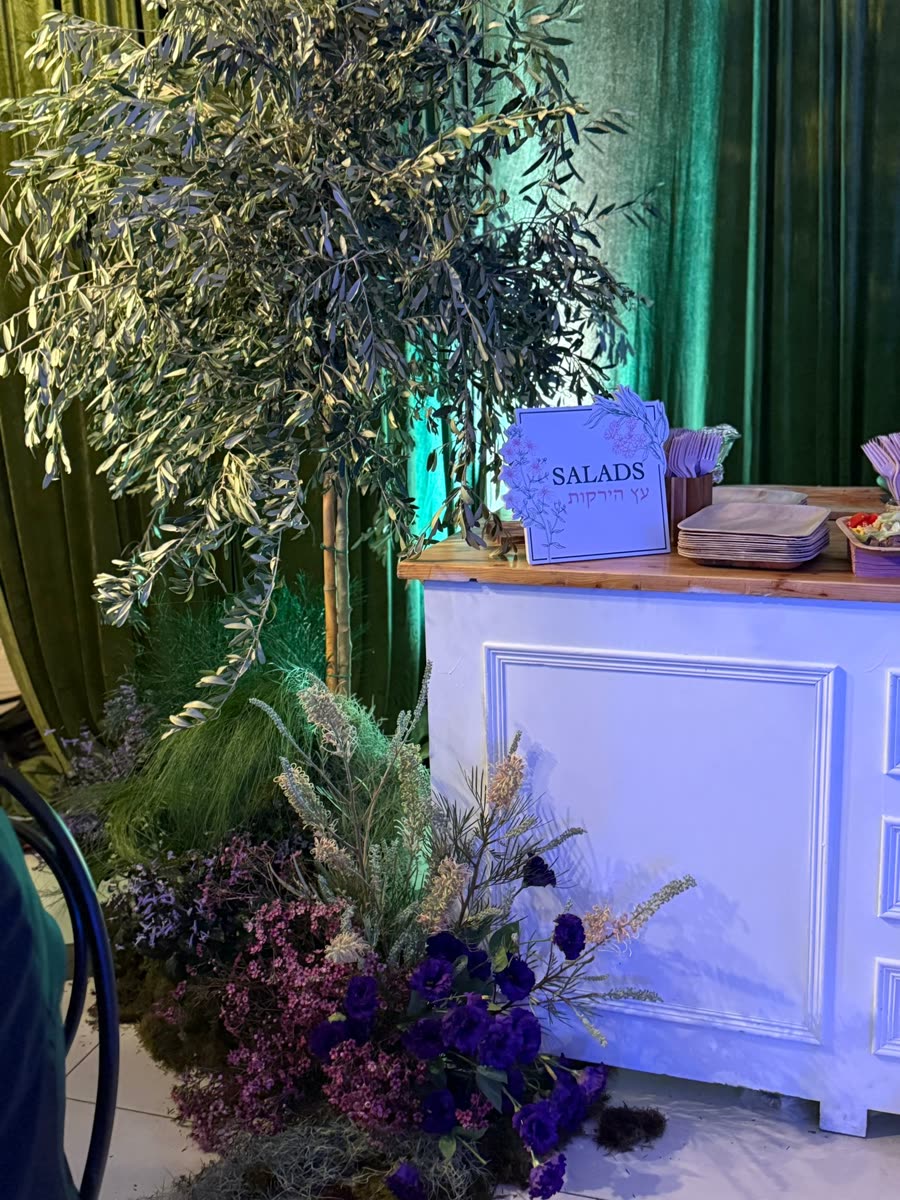 Floral stage backdrop lit for a simcha